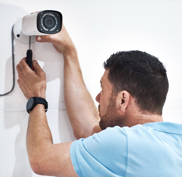 Technician Installing Security Camera